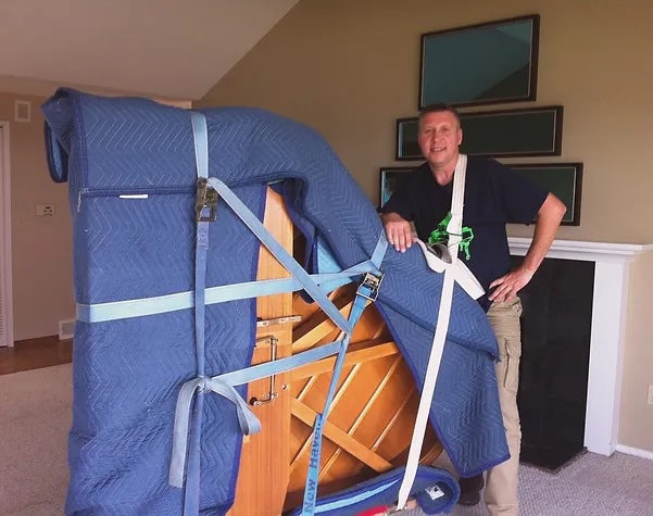 A man standing next to a large blue object