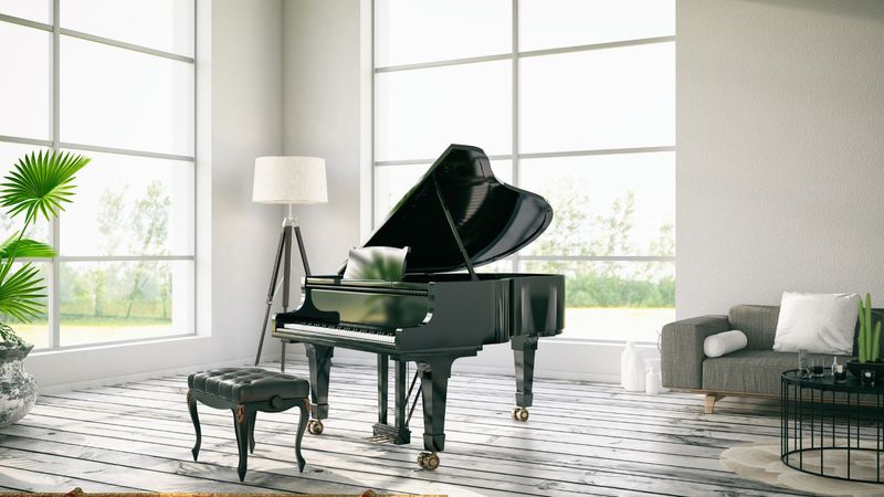 A living room filled with furniture and a grand piano